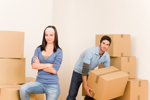 Movers handling flat access and stairs in a Peckham property