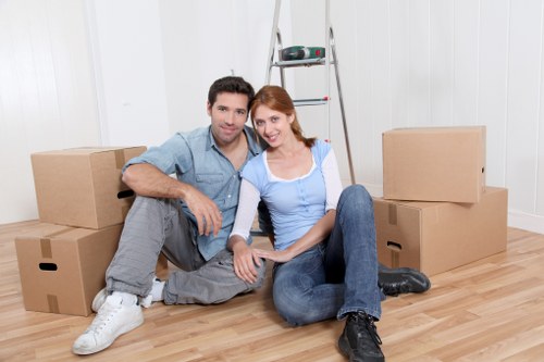 Trained movers handling furniture carefully during a Peckham van service